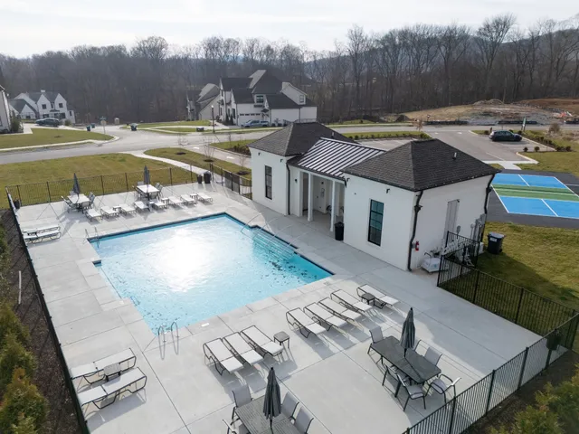 a large kitchen with a lot of counter space and wooden floor