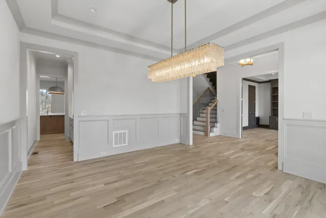 a view of a room with wooden floor and staircase