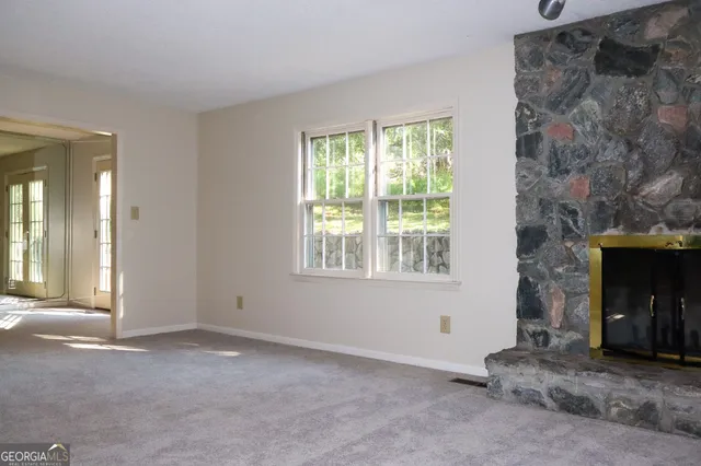 a view of an empty room with a fireplace