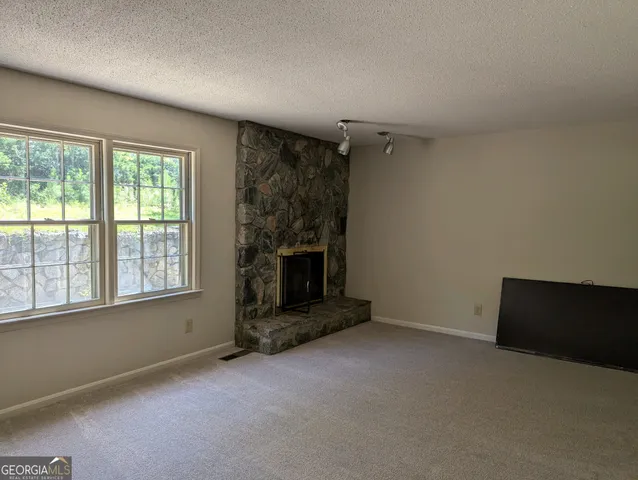 an empty room with a fireplace