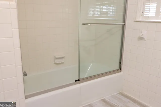 a bathroom with a glass shower door