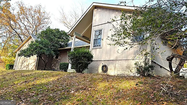 a view of a house with a snow on the tree