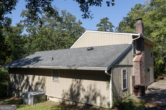 a view of house with trees in the background