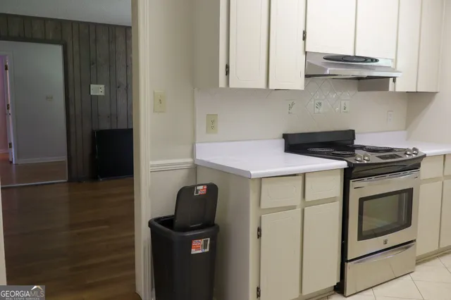 a kitchen with stainless steel appliances granite countertop a stove and a microwave