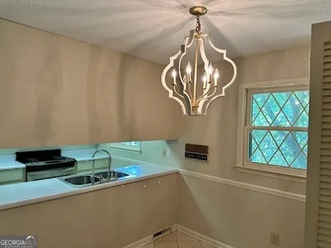 a kitchen with a sink and a chandelier