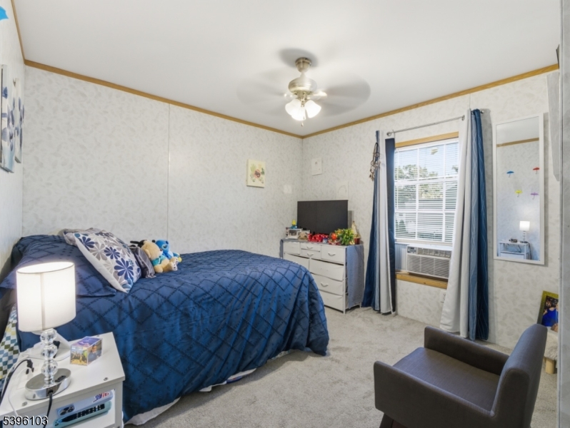 18 3rd Street Woodbridge, NJ 07001 - Photo 8 of 10 a bedroom with a bed and a chandelier