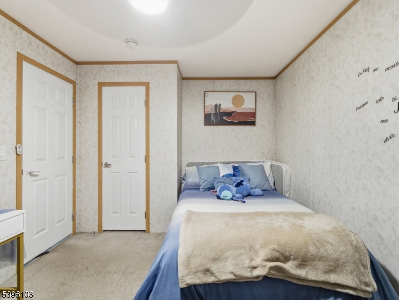 18 3rd Street Woodbridge, NJ 07001 - Photo 9 of 10 a bed sitting in a bedroom next to a bathroom