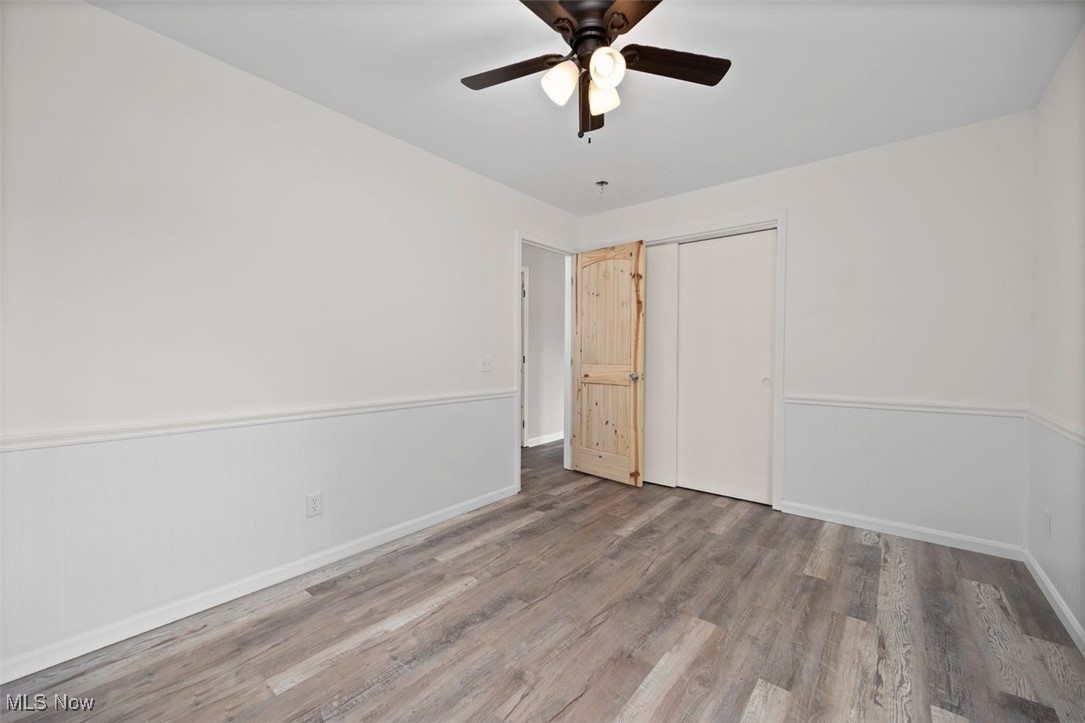 1515 Butler Road New London, OH 44851 - Photo 20 of 39 Unfurnished bedroom featuring wood finished floors, a closet, and a ceiling fan