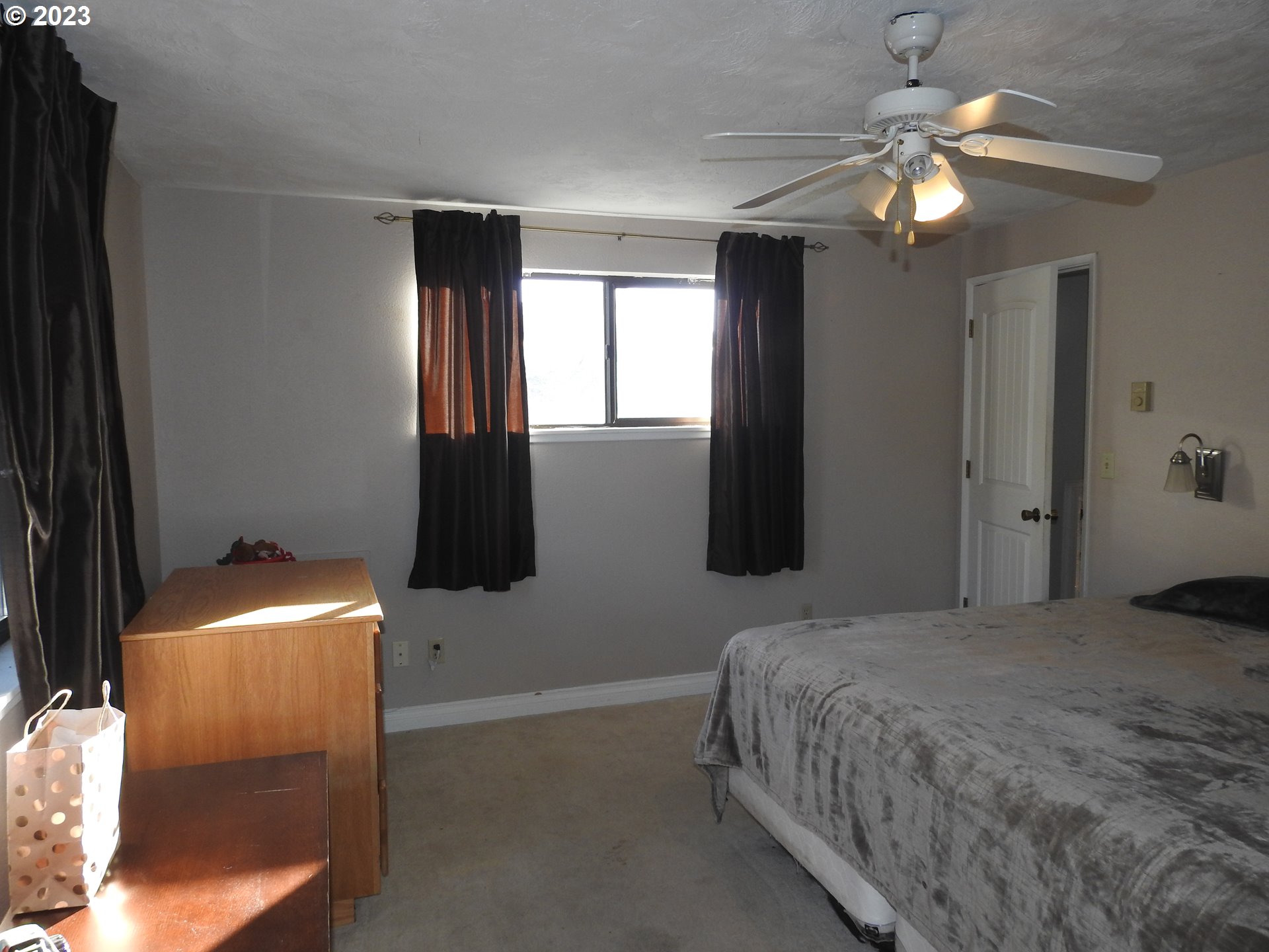 968 South 55th Place Springfield, OR 97478 - Photo 21 of 32 a bedroom with a bed and a chandelier