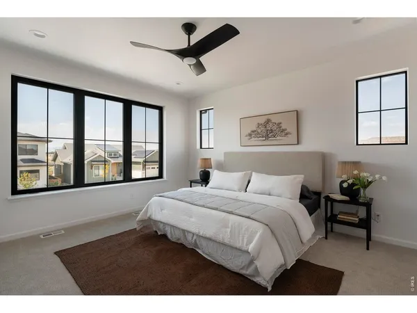 a bedroom with a large bed and a large window