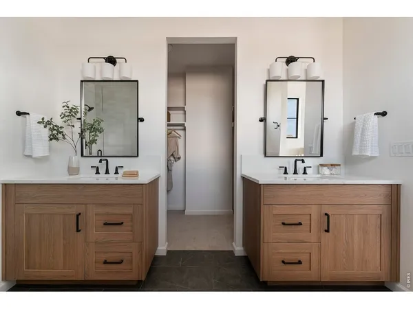 a bathroom with a sink double vanity and a mirror