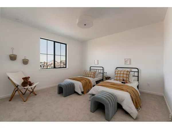 a bedroom with two beds and a window