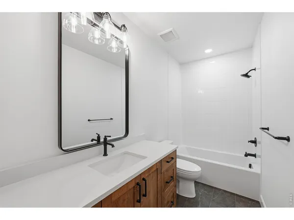 a bathroom with a sink a toilet and a tub