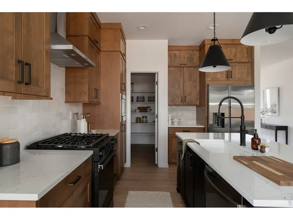 a kitchen with stainless steel appliances a sink stove and cabinets