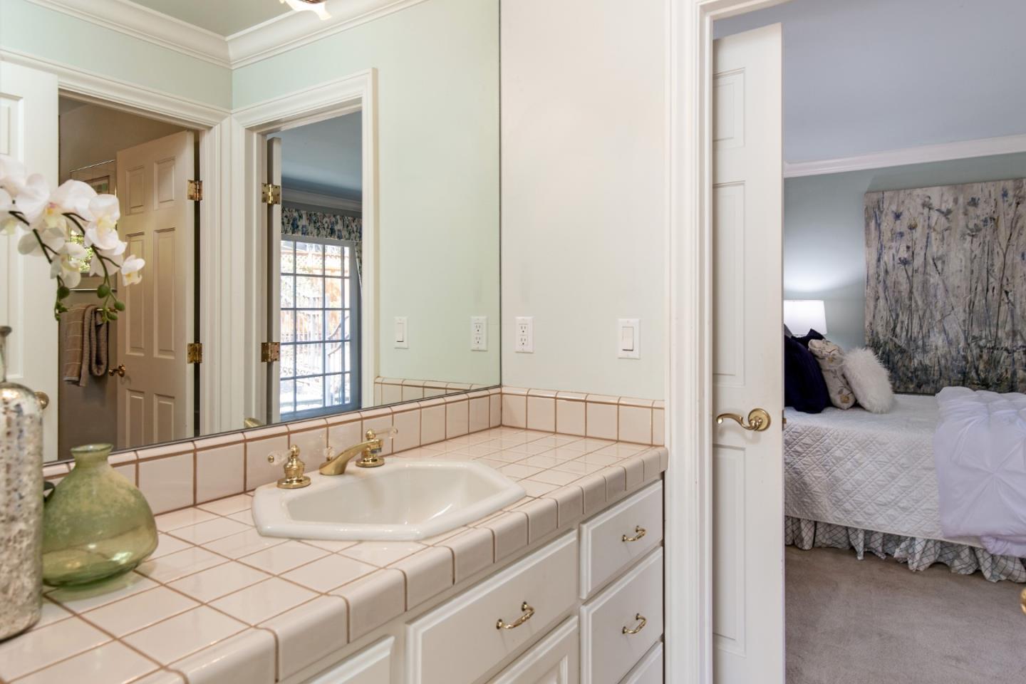 18540 Bicknell Road Monte Sereno, CA 95030 - Photo 31 of 51 a en suite bathroom with a granite countertop sink and a mirror