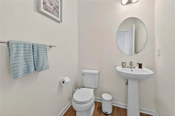 a bathroom with a toilet a sink and a mirror