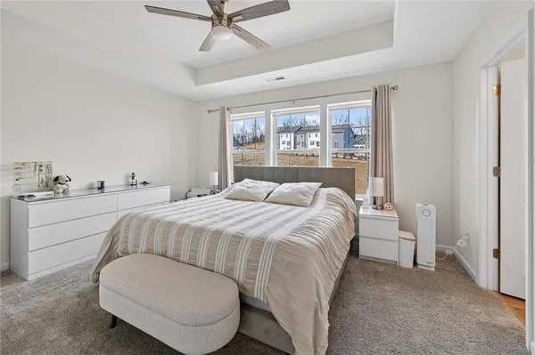 a bedroom with a bed and a large window