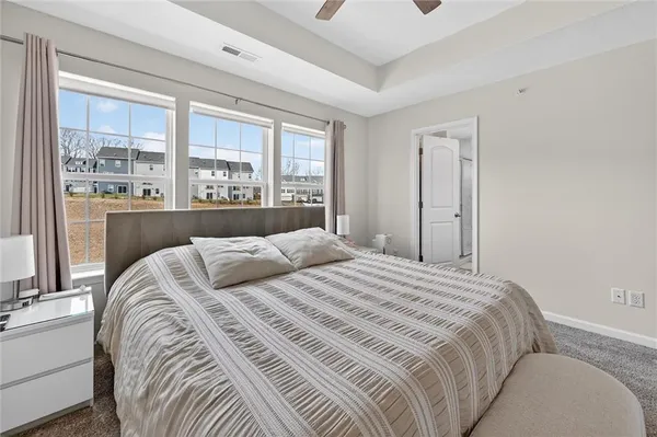a bedroom with a large bed and a large window