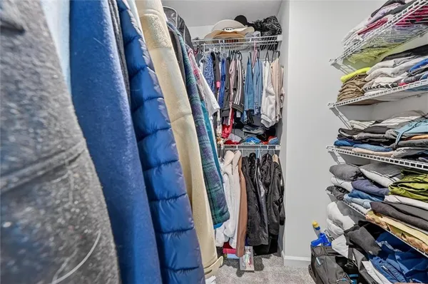 a view of walk in closet with clothes