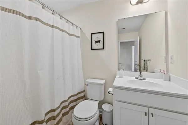 a bathroom with a toilet a sink and a mirror
