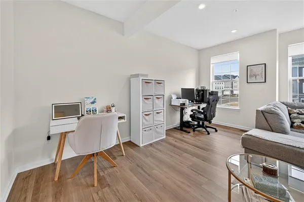a view of a livingroom with workspace and a couch