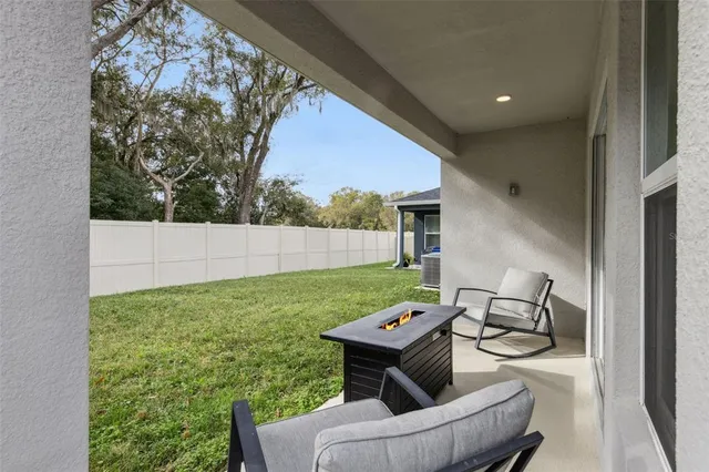 a backyard of a house with table and chairs