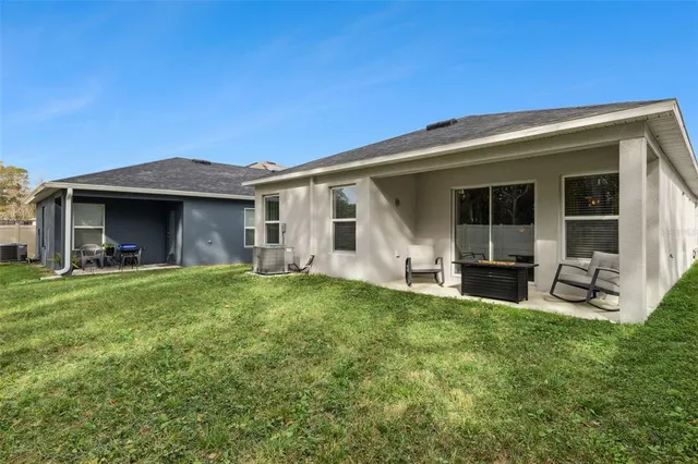 a view of a house with backyard porch and garden