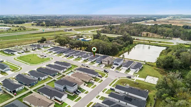 an aerial view of a house with a lake view