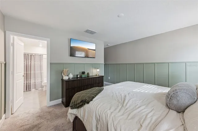 a bedroom with a bed and a tv