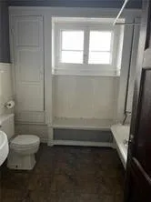 a bathroom with a toilet a sink and a bathtub