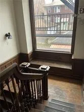 a blue chair sitting in front of a window