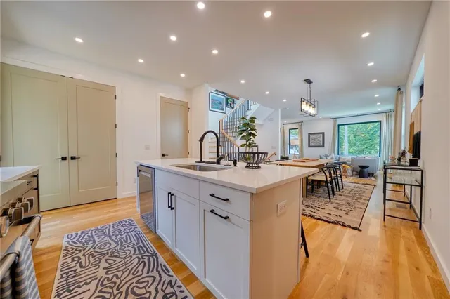 a kitchen with a sink and wooden floor