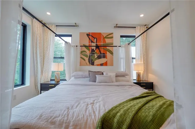 a bedroom with a large bed and a large window