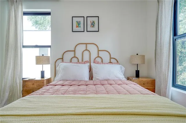 a bedroom with a large bed and a window