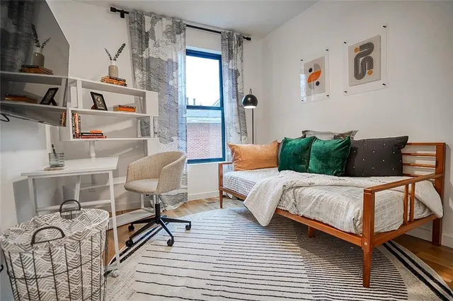 a bedroom with a bed and a couch