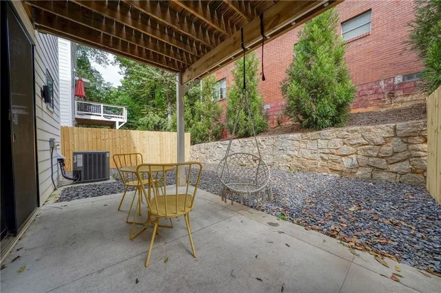 a view of a patio with table and chairs and potted plants