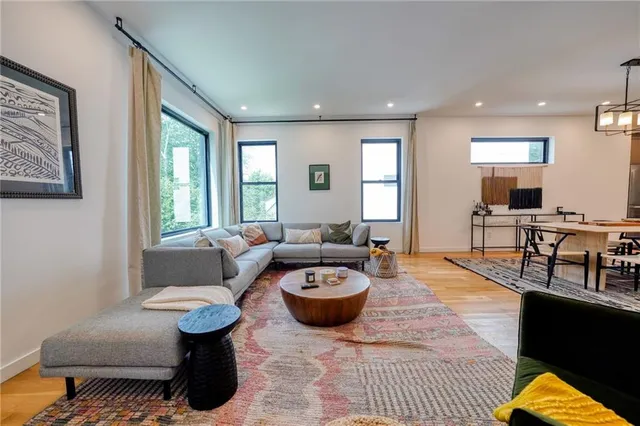 a living room with furniture and wooden floor