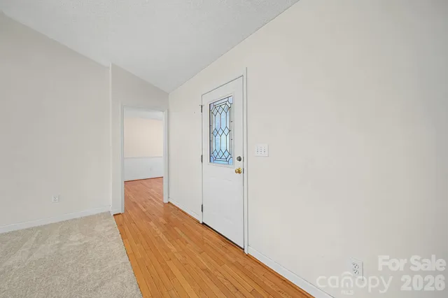 a view of a hallway with closet and bathroom