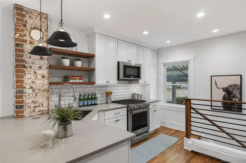a kitchen with a sink cabinets and window