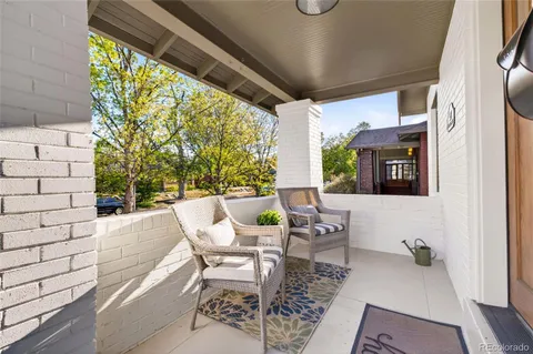 a view of a patio with table and chairs and potted plants