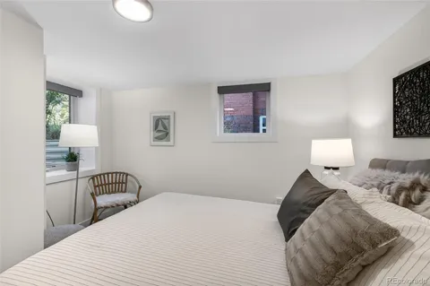 a bedroom with a bed and a lamp
