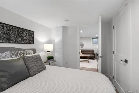 a bedroom with a bed and a view of kitchen