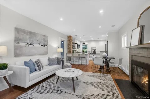 a living room with furniture a fireplace and a table