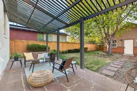 a view of a patio with table and chairs and potted plants