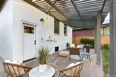 a view of a patio with table and chairs potted plants with wooden floor