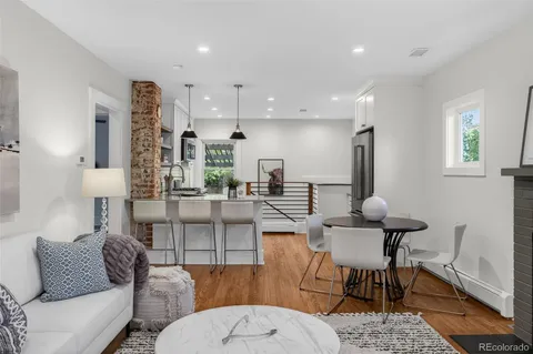 a living room with furniture a rug and a table