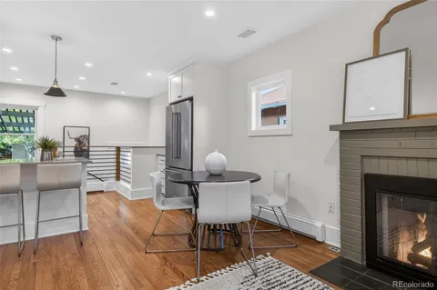 a living room with furniture a fireplace and a table