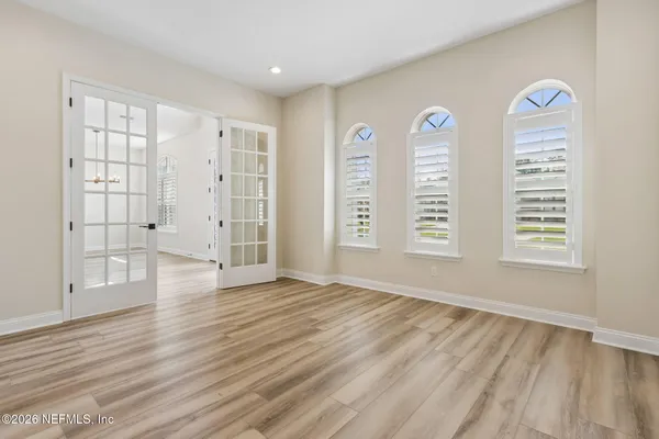 a view of a room with wooden floor and ceiling fan
