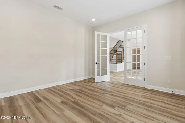 a bathroom with a double vanity sink large mirror and a bathtub