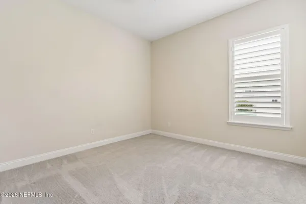 a view of a room with wooden floor and windows